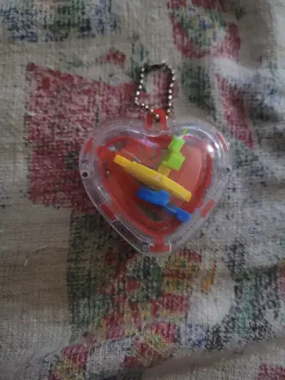 heart-shaped 3D maze puzzle keyring., View more