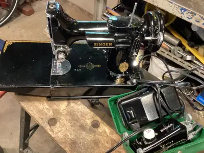 For sale is a Singer Featherlight sewing machine together with all attachments, instruction booklet...
