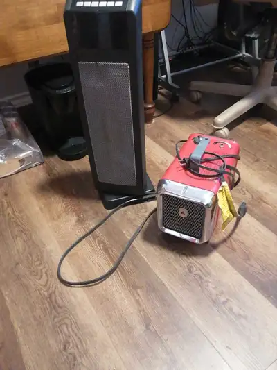 Two 110 volt electric heaters one black Garrison oscillating with timer for $60 and one red Honeywel...