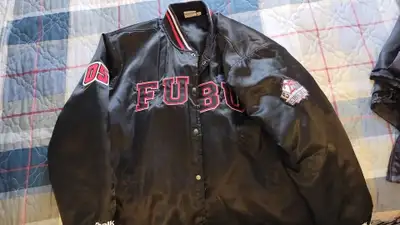 Two xl Los Angeles sweatshirts , one black and one gray and also a large 25th Anniversary Fubu Chalk...