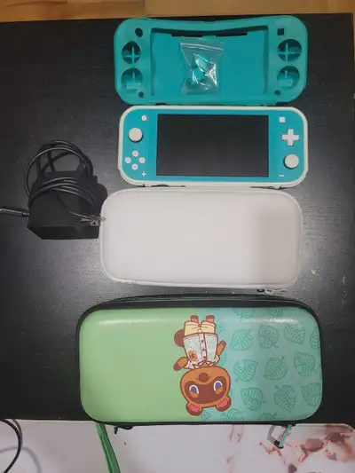 Turquoise Nintendo Switch Lite with Nintendo accessories , View more
