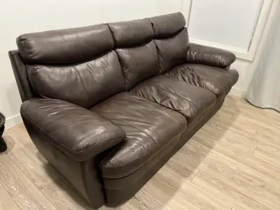 I'm selling a used living room set that includes a chocolate brown leather sofa, loveseat, and a gla...