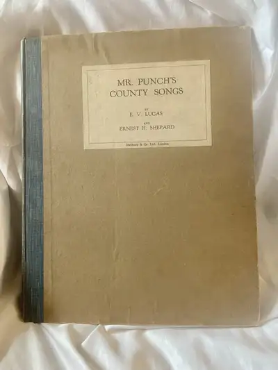 Dive into a piece of literary history with this 1928 edition of "Mr. Punch’s County Songs" by E.V. L...