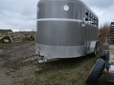 2018 Corn Pro 16' stock trailer. Floor is excellent. Rubber mats used to protect floor and mats are...