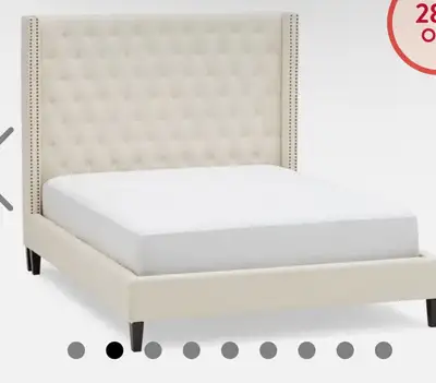Add a touch of elegance to your bedroom with this used Wingback bed frame, designed to fit a queen-s...