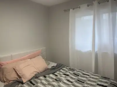 This is a cozy, shared living space in a two-bedroom apartment, perfect for a student or young profe...