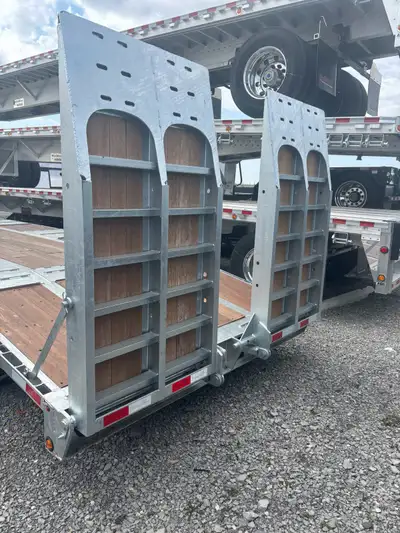 Galvanized Gincor Tridem Equipment Drop Decks with air assist rear ramps, and a 5’ Beavertail for ea...