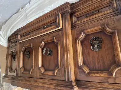 Add a touch of vintage charm to your dining area with this beautiful wood hutch featuring ornate det...