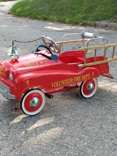 Relive the glory days with this vintage-style Volunteer Fire Dept. Truck No. 2 pedal car, a striking...