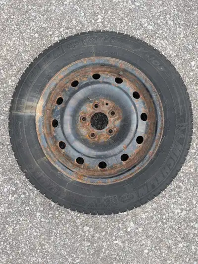 Set of 4 Michelin X-Ice winter tires mounted on steel rims, providing grip and safety for your cold-...