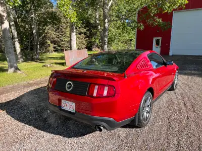 This low mileage 2011 Ford Mustang GT features a powerful 5.0L V8 engine, striking red exterior, and...