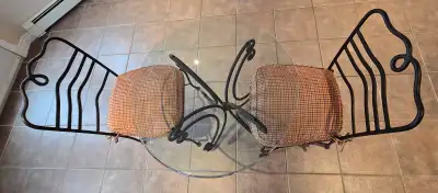 Wrought iron table and 2 chairs. Glass top has a few scratches and no chips. 2 different sets of sea...