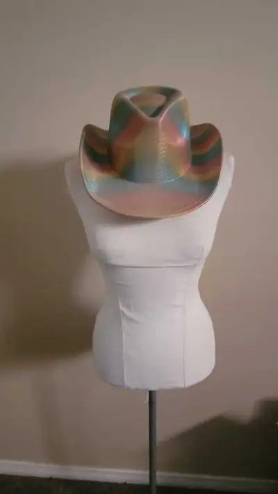 Add a touch of vibrant flair to your wardrobe with this eye-catching rainbow cowboy hat, featuring a...