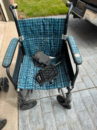 Two class wheelchairs, one blue one black with laser stands