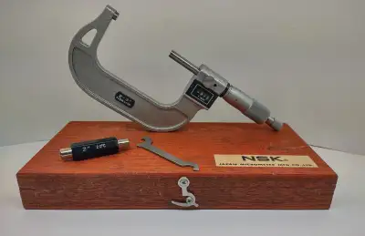 NSK Outside Digital Micrometer (550-603) Includes wooden case, 2 inch standard, and wrench. ...