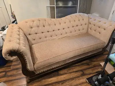 Antique-style tufted camelback sofa, carved wood trim, View more