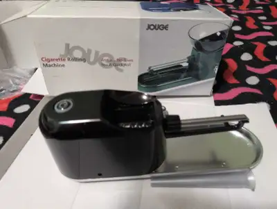 This is a JOUGE Cigarette Rolling Machine. This electric rolling machine makes an easy tap to give y...