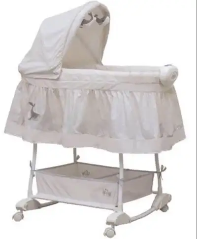 Adorable baby bassinet. Features a canopy, storage basket, and wheels. Off-white colour scheme with...