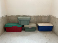 Four plastic storage bins with lids