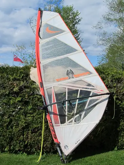 wind surf surfer surfing windsurf windsurfer windsurfing sailboard sail board This sail has seen a l...