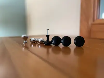 4 black and 3 chrome knobs from a gently used vanity and new med cabinet