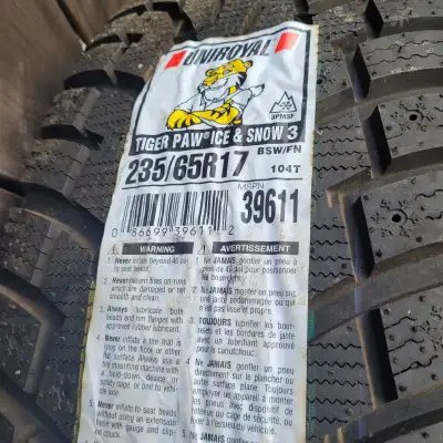 These are a set of used Uniroyal Tiger Paw Ice & Snow 3 winter tires, size 235/65R17, ready to tackl...