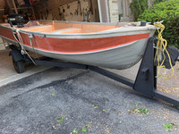 A 14 fool aluminum fishing boat with a Mercury engine, trailer a
