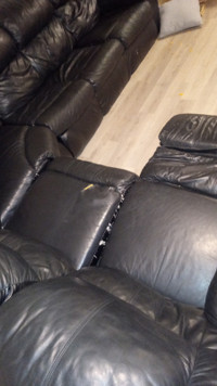 Black leather couch fold out bed .