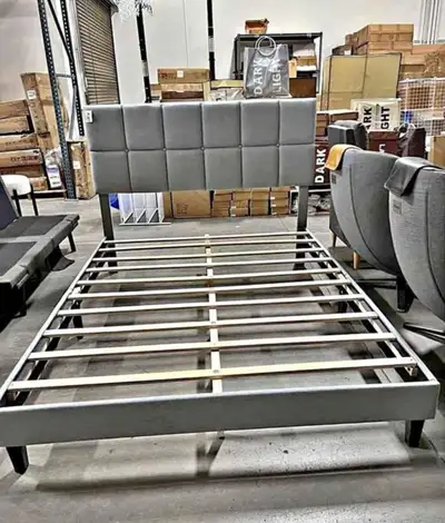 This is a queen-size bed frame featuring a stylish grey upholstered headboard and a sturdy wooden sl...