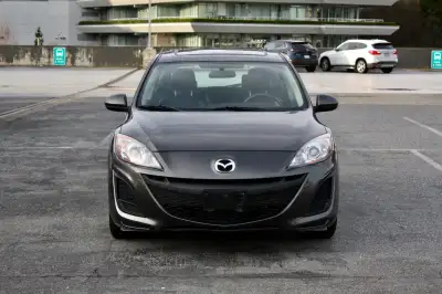 2010 Mazda 3 GX Hatchback with 212,700 KM | Graphite grey metallic exterior paired with a black leat...