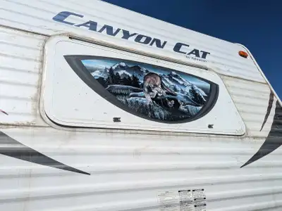 2013 Forest River Canyon Cat pull behind trailer. Double bed bunks, bathroom, fridge, push out with...