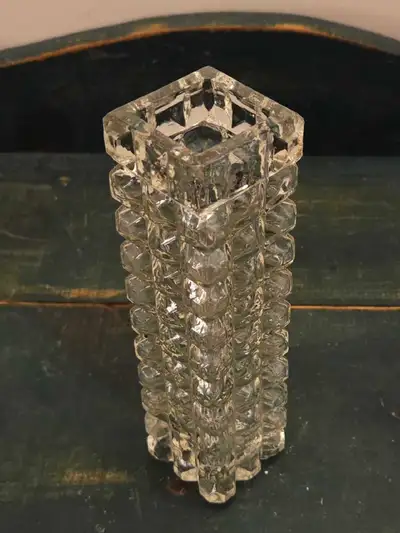 This is a vintage art glass vase with a stunning geometric design, perfect for adding a touch of mid...