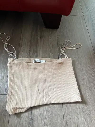 Lightweight beige crop top. Ribbed fabric. Thin straps.