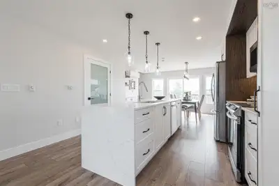 A beautifully designed single-family detached home with an impressive stone and vinyl exterior. The...