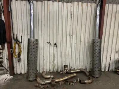 Twin stacks 5”from turbo to a 4” tee and 4” to mufflers and out with five inch for stacks small dent...