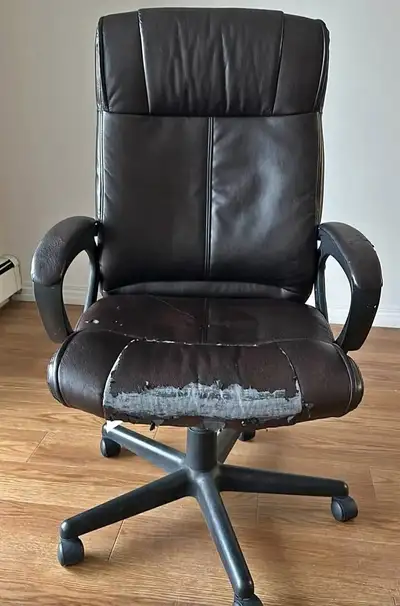 Faux leather office chair has a dark brown color. It is equipped with a five-point rolling base and...
