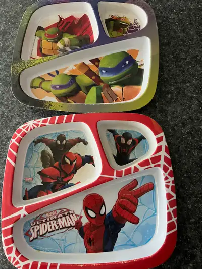 Two kids serving trays sectioned in hard plastic one in Spider-Man second in ninja turtles