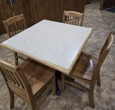 36 x 36" wood table with cast base. 4 wooden chairs. Very sturdy, heavy table & chairs. Sold in sets...