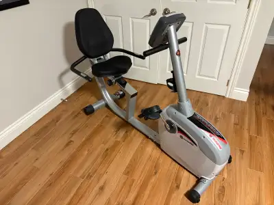 Achieve your fitness goals with this Schwinn recumbent exercise bike, featuring a comfortable seat a...