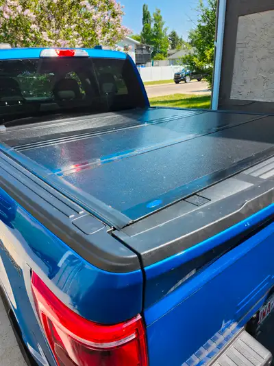 Tri-fold hard top tonneau cover fits 2021 F150 5 foot 5 inch truck box. Black color and in very good...