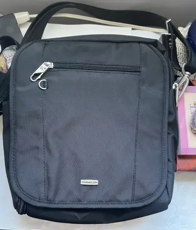 This is a used Travelon anti-theft black iPad bag in good condition, perfect for keeping your tablet...