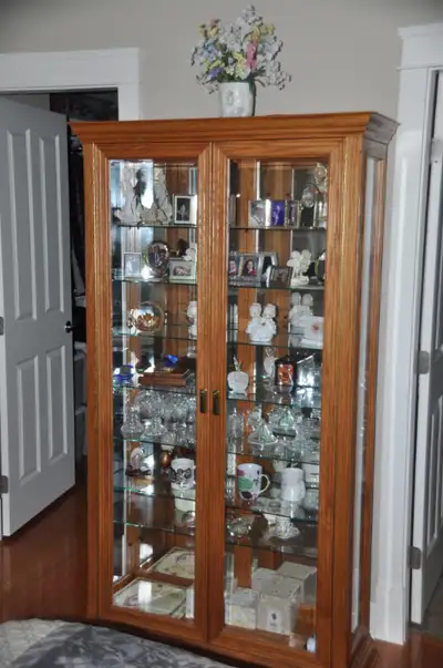 Solid Oak Curio/Hutch. Seven glass display shelves included. Original Price $1200+taxes/