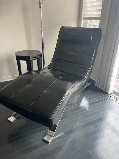 Black faux leather chaise lounge chair Reclining and adjustable 68x28x37 Paid $900 Excellent conditi...