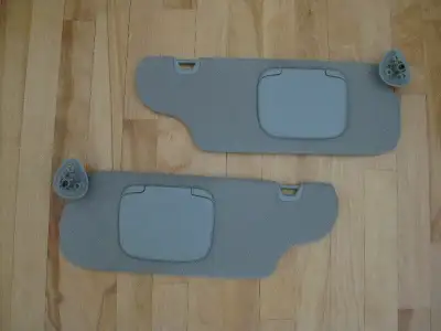 Left and right sun visors - shade set, with clips, lighted mirror, from a 2000 Ford Taurus, gently u...