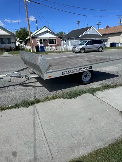 This Aluma tilt deck trailer is perfect for hauling your snowmobile or other gear, featuring an all-...