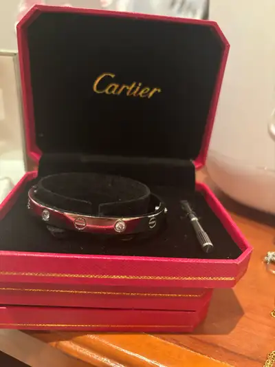 Silver-Tone Love Bracelet with Crystals (Cartier Style) This elegant silver-tone bracelet features t...