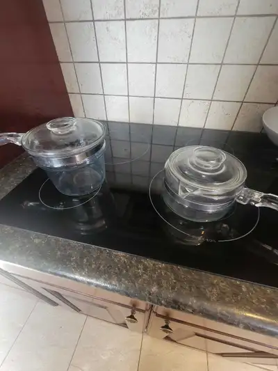These vintage glass handled Pyrex pots are perfect for cooking and serving, each featuring a clear g...