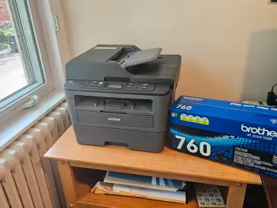 Well functioning black & white laser printer with extra cartridge ($70 value) and nice printer table...