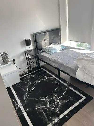 This room is part of a shared apartment space. It includes a bed, a desk, a chair and , mini fridge,...