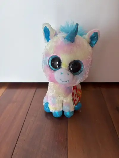 Pastel mulitcolored unicorn stuffed animal with big eyes. Original tag is attached. Size: approx 7"...
